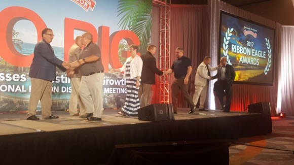 overhead door distributors accepting awards in boca raton