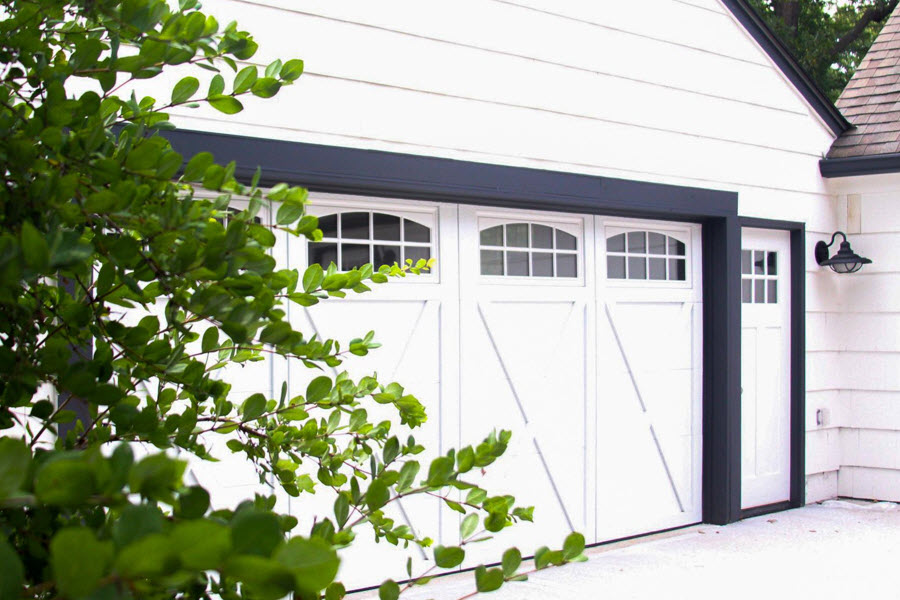 white courtyard garage door in home transformation