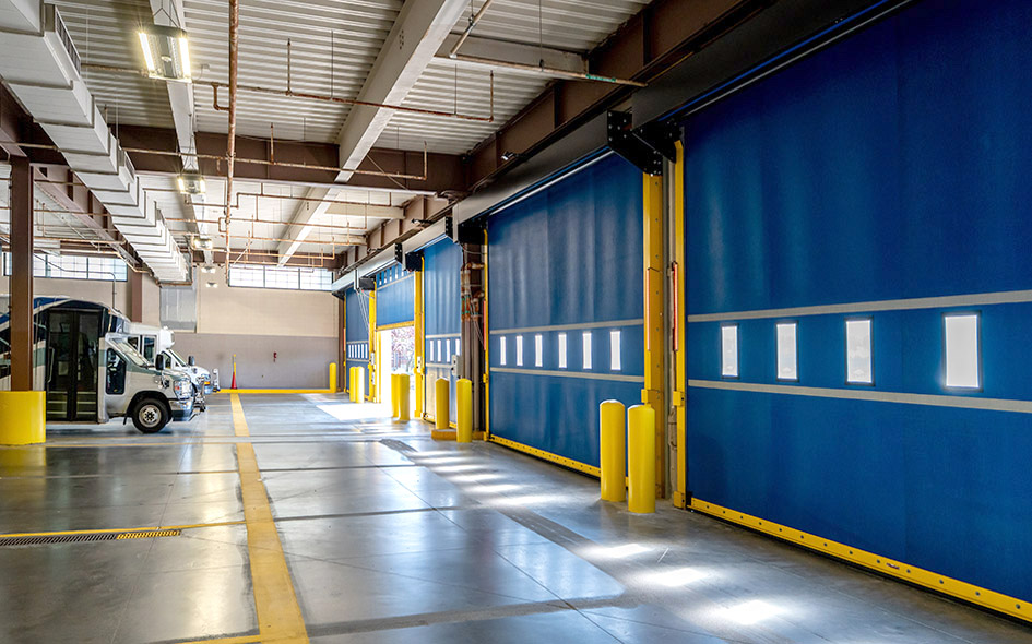 blue commercial fabric doors with a truck in the background