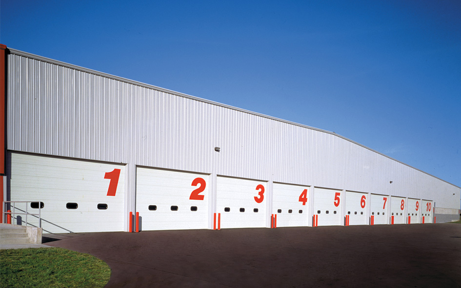 white sectional steel commercial doors with red numbers on them