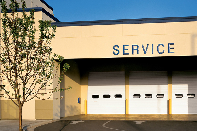 three white sectional steel commercial doors